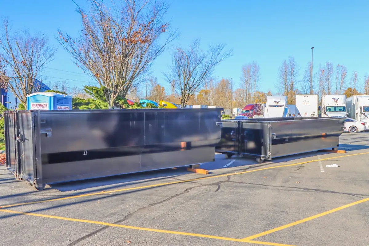 Professional dumpster rental service with roll-off container on residential driveway in Kronenwetter